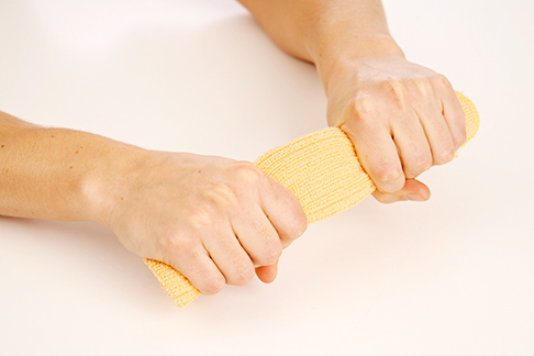 Gerolltes Handtuch im Sekundenrhythmus kräftig drücken. © Gelenk-Klinik Übung mit Handtuch