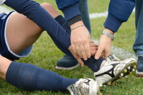Durch ein Umknicken beim Sport kann das Außenband im Sprunggelenk überdehnen oder reißen. © massimhokuto, stock.adobe.com Bänderriss beim Fußball